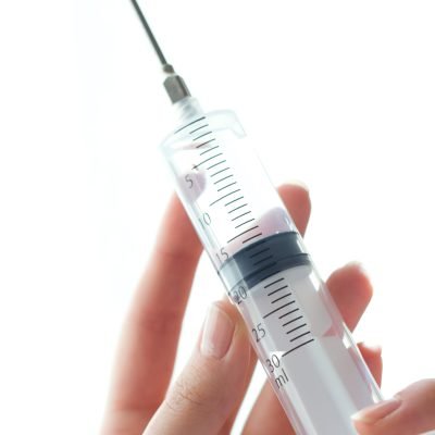 woman hand holding syringe isolated white